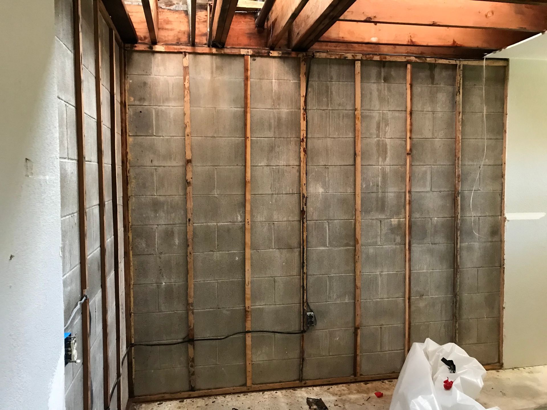 A room with a brick wall and wooden beams