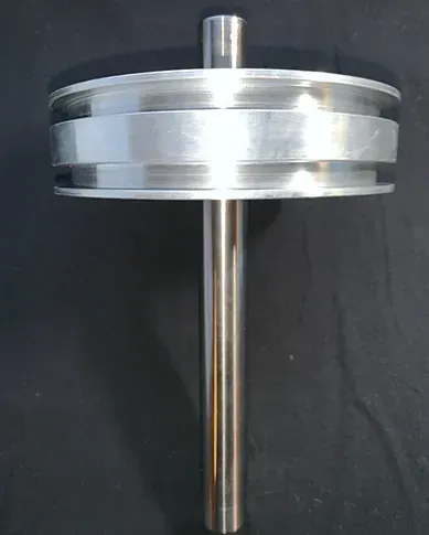 a close up of a metal object on a black surface .