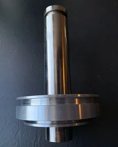 a close up of a metal object on a black surface .