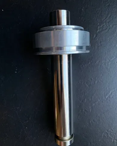 a close up of a metal object on a black surface .