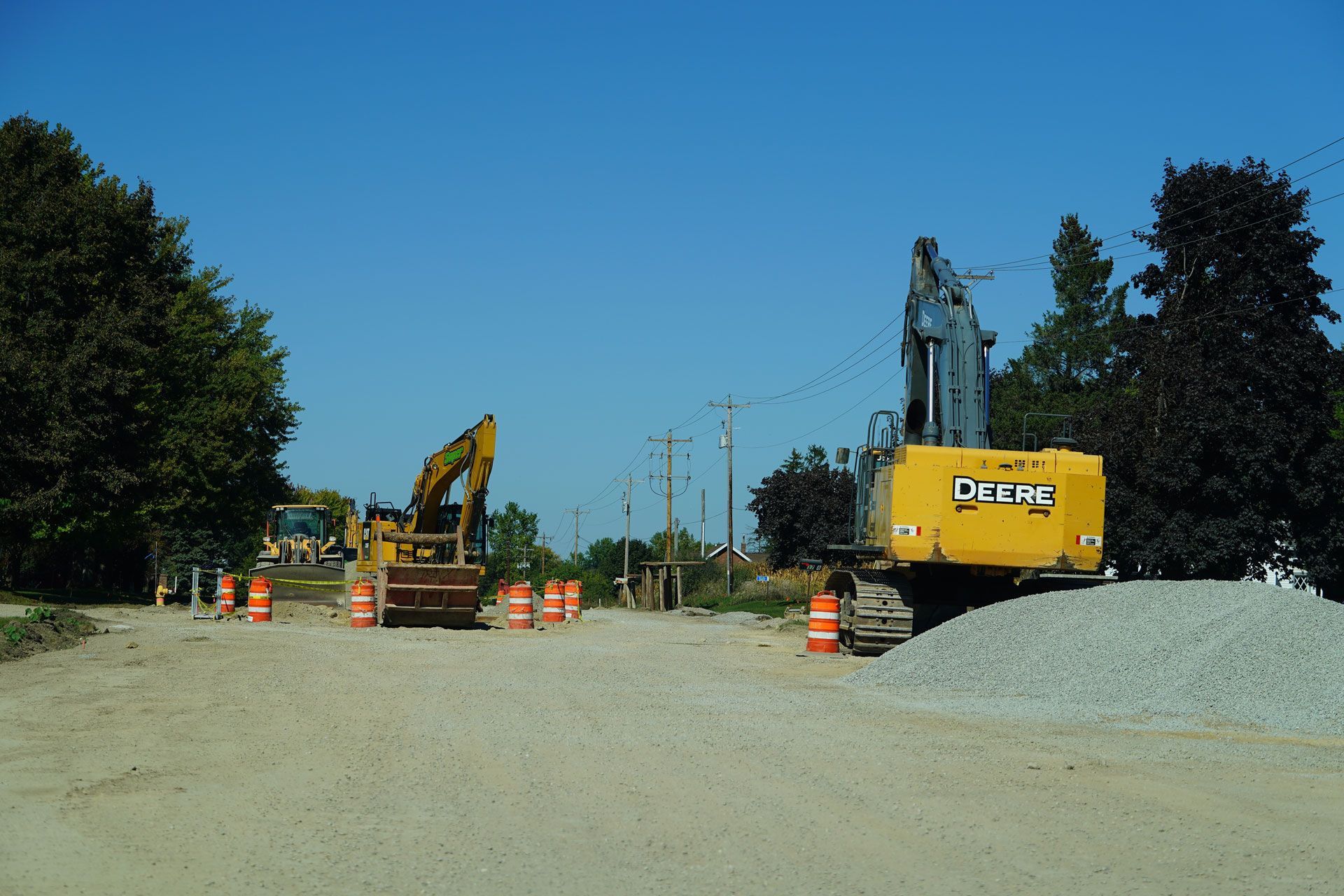 Road construction site: Yellow asphalt rollers compacting fresh black asphalt