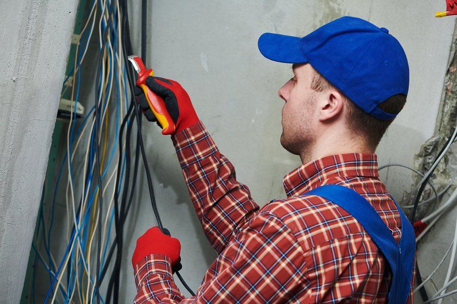 Electrician cutting industrial wire