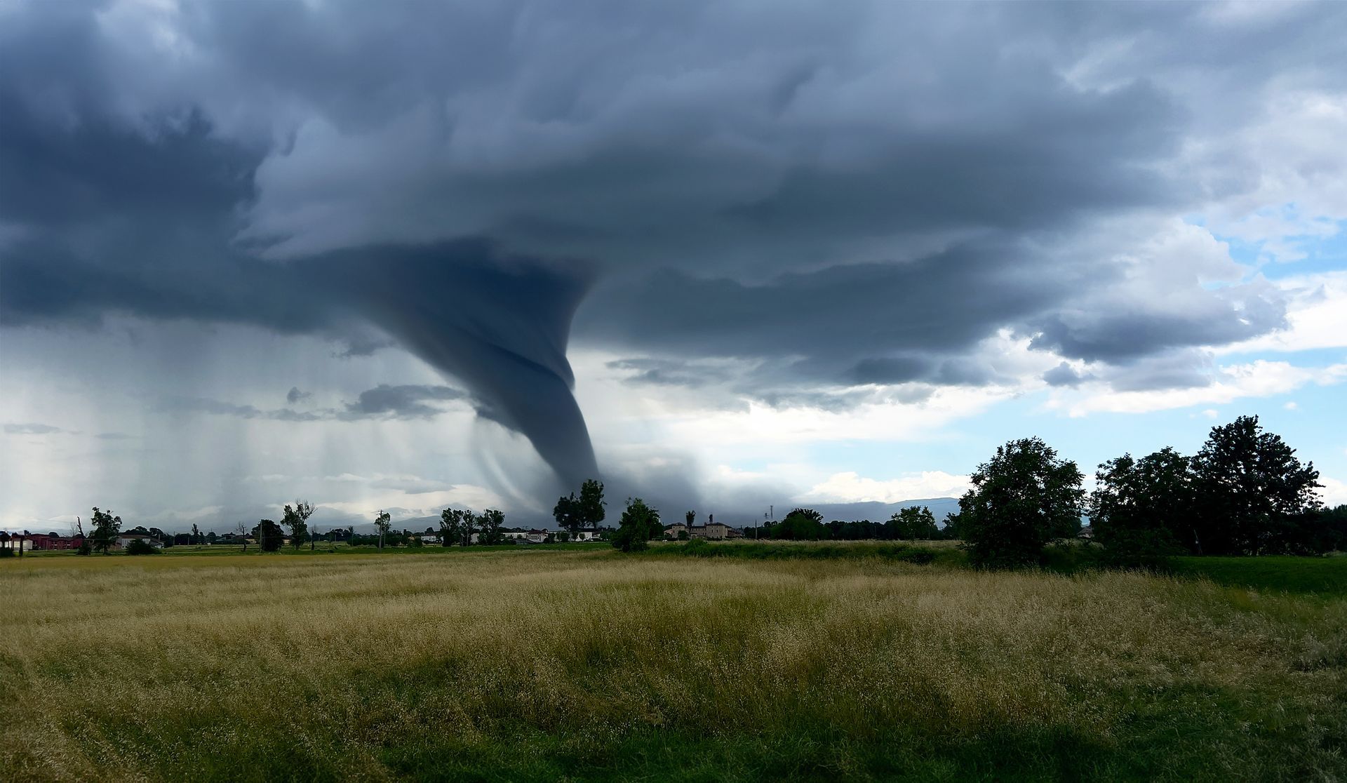 Tornado in a field near treeline
