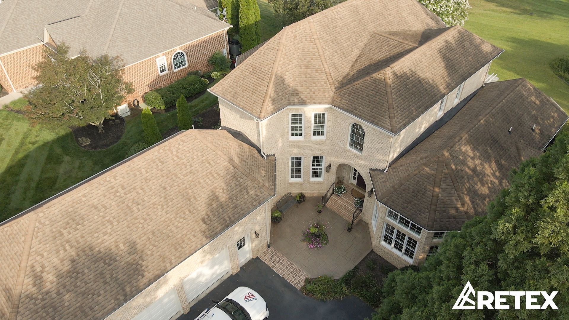 Drone image of RETEX roof replacement in Bon Air VA 23235.  Tamko Titan Olde English asphalt shingles and TPO flat roof.