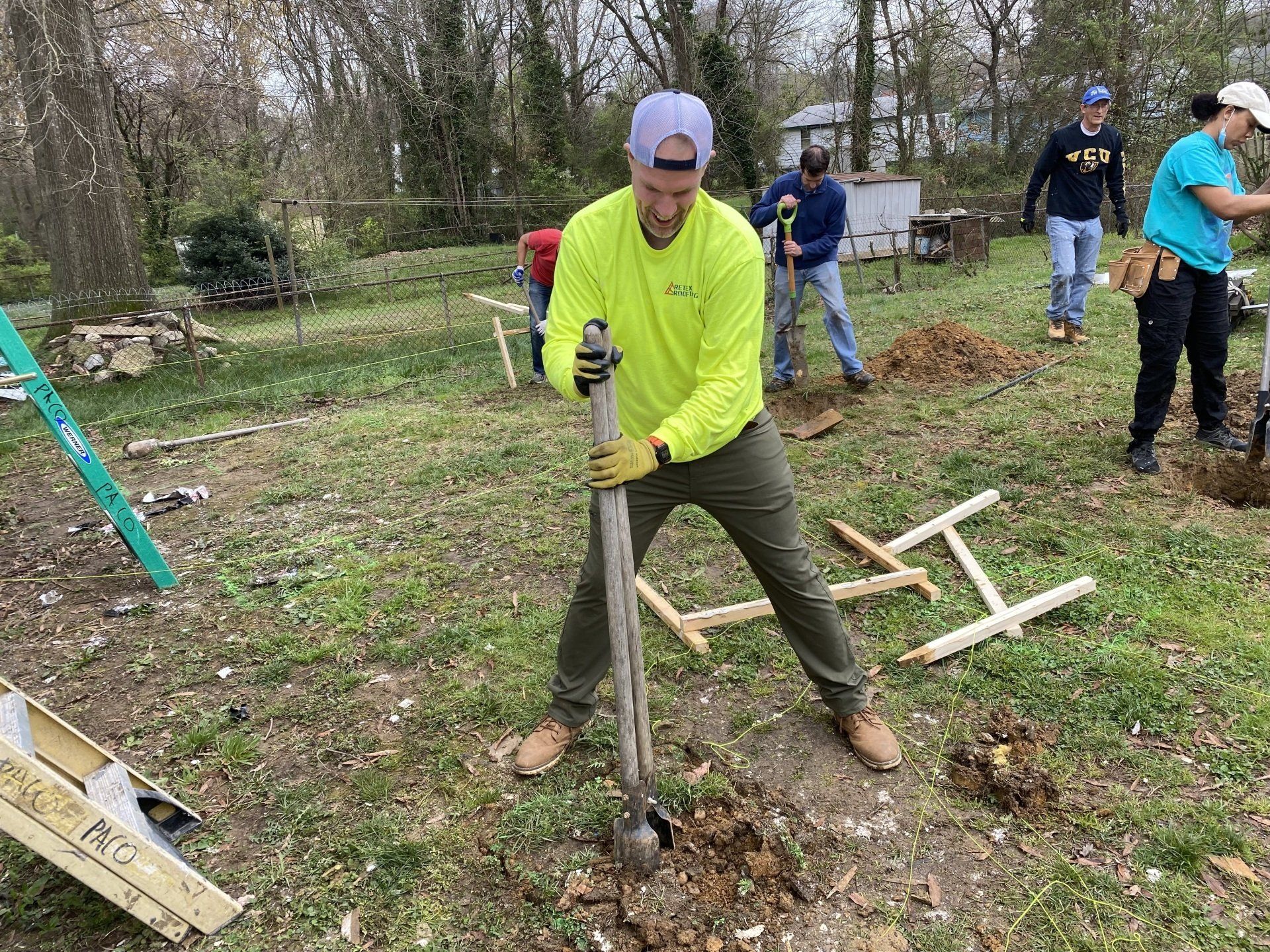 Image of RETEX's Mark Erickson volunteering with Richmond Habitat for Humanity, digging a hole for a foundation post.
