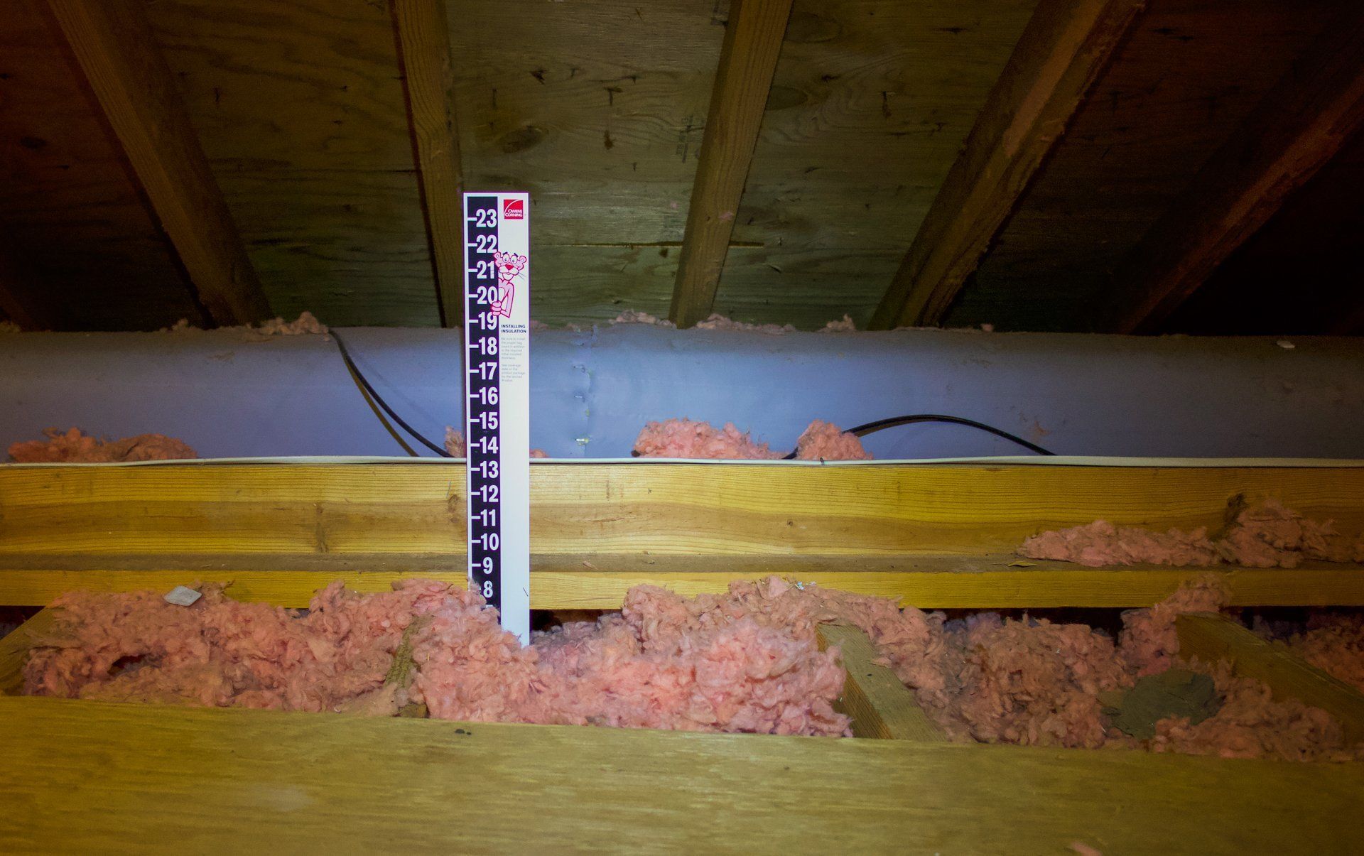 Image of ruler measuring depth of attic insulation in North Chesterfield VA home. 