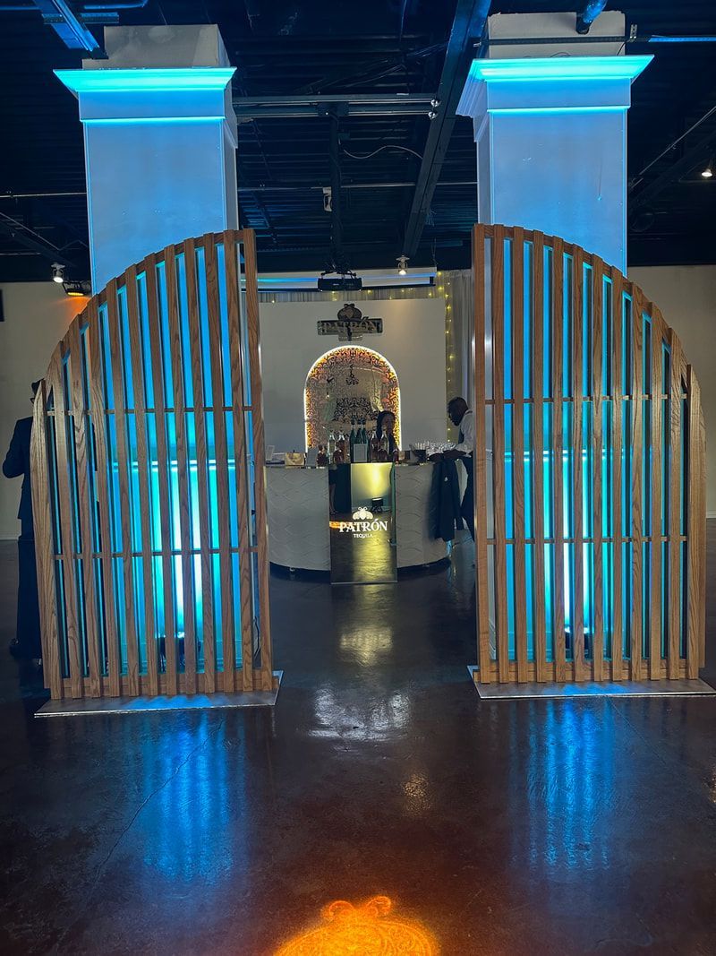A wooden gate in a room with blue lights behind it.
