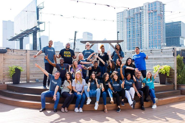 A group of people are posing for a picture on a rooftop.