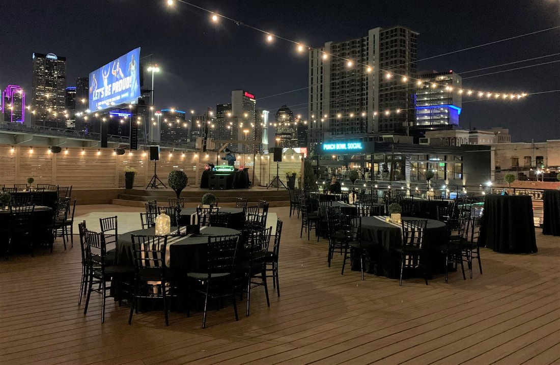 A patio with tables and chairs set up for a party at night.