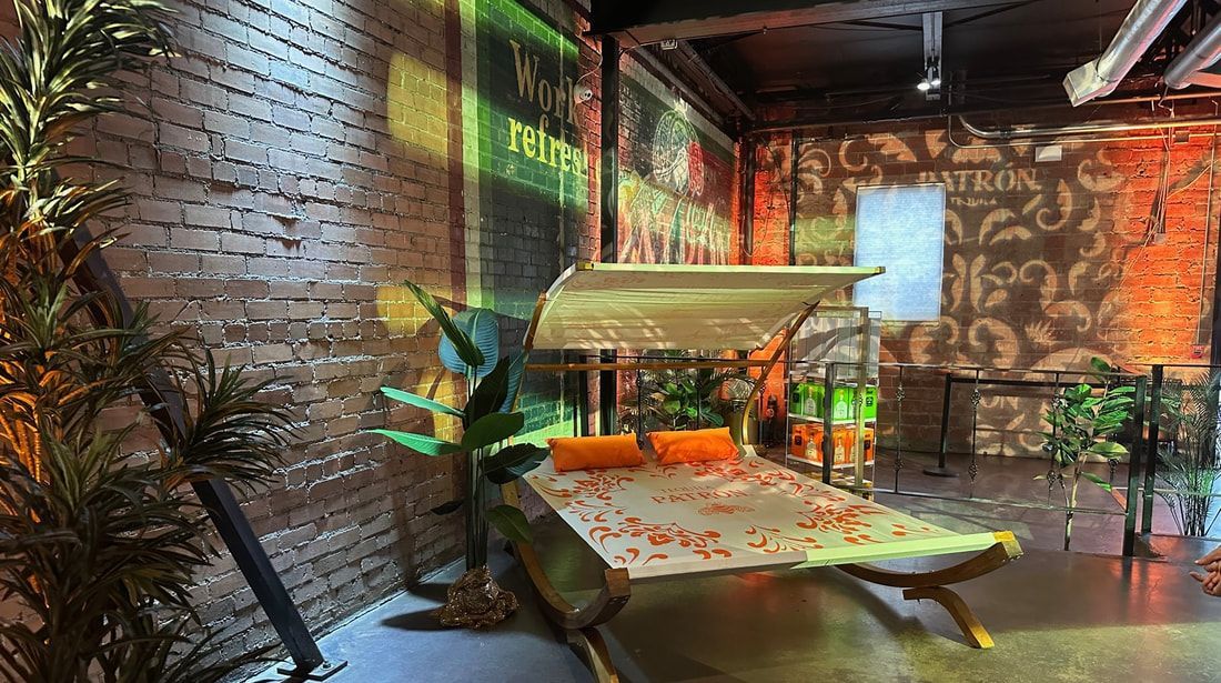 A room with a brick wall , a table and a plant.