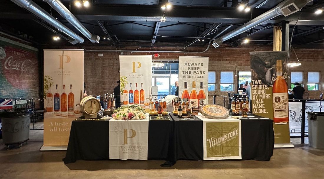 A large table with a lot of food and drinks on it in a room.
