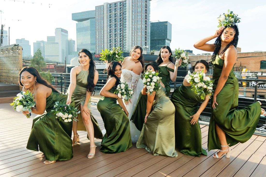 A bride and her bridesmaids are posing for a picture on a deck.