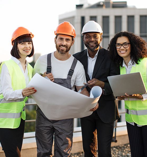 Construction team reviewing blueprints on a rooftop, wearing hard hats and safety vests.