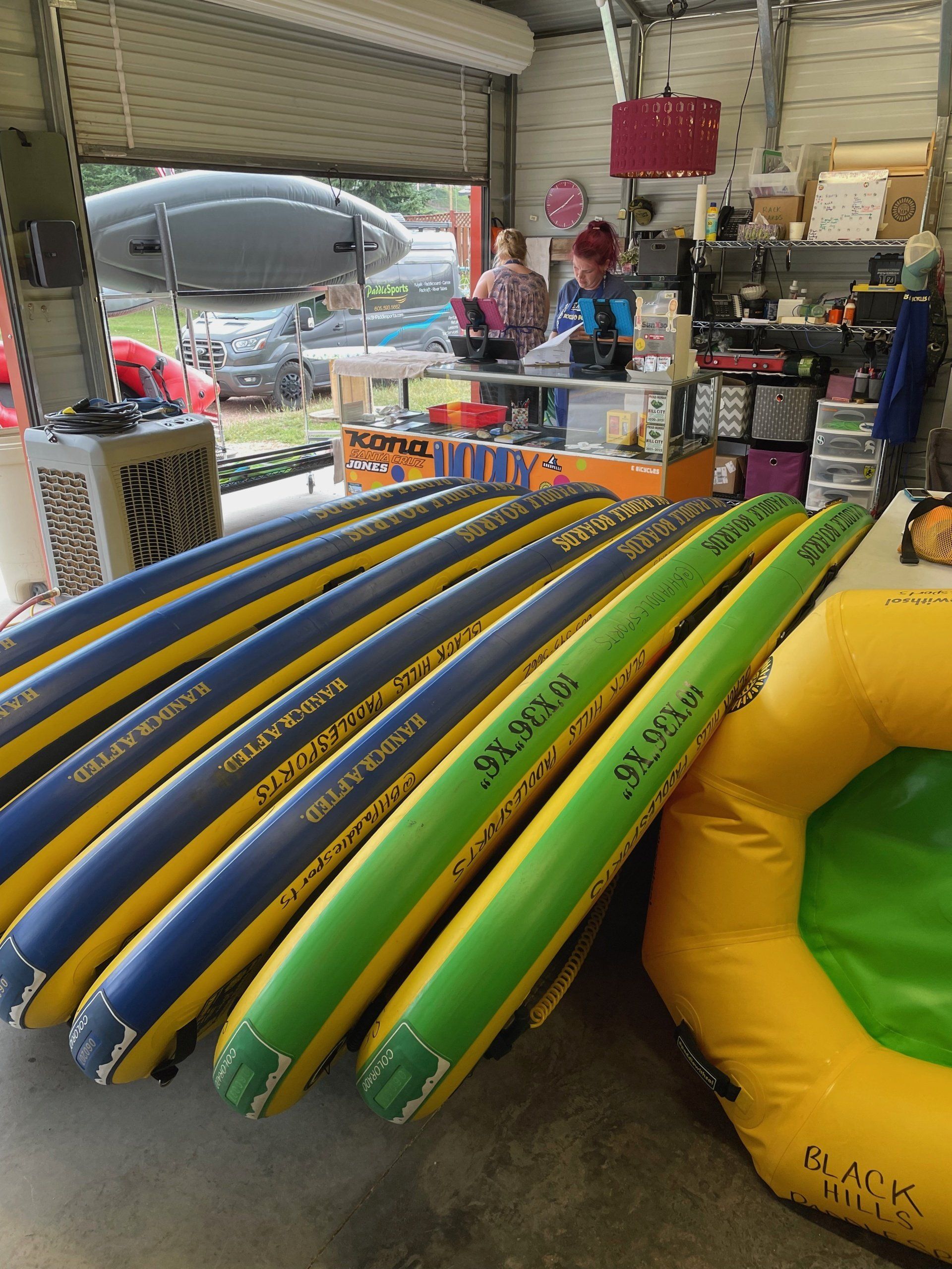 A bunch of inflatable tubes are stacked on top of each other in a garage.