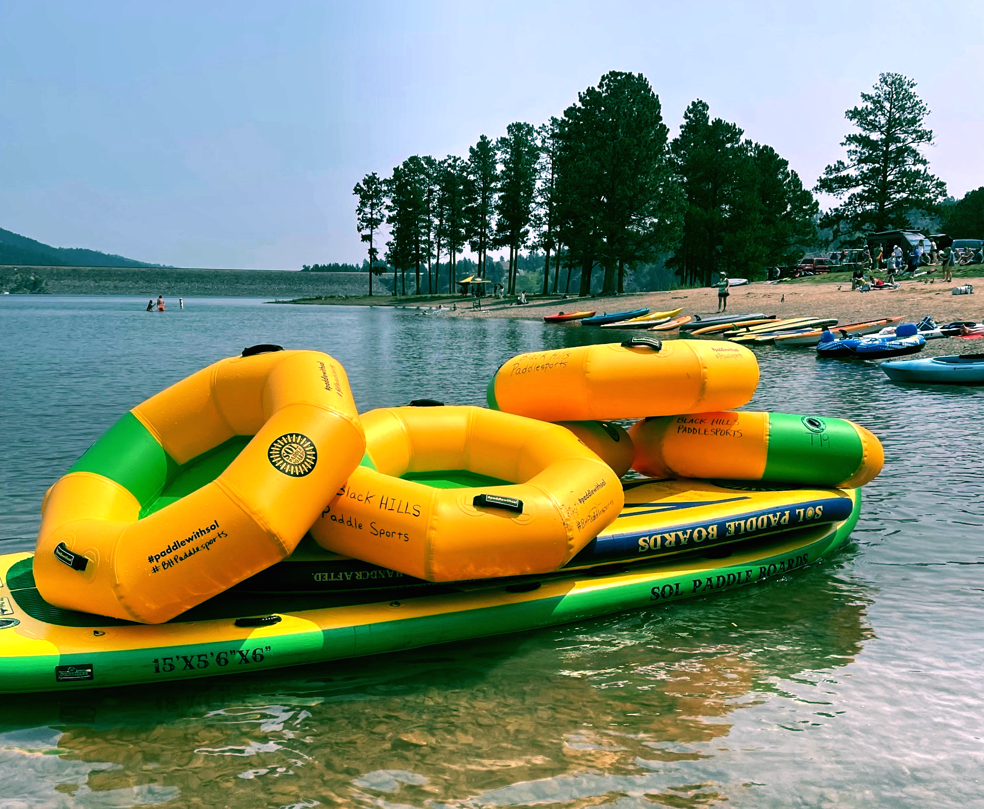 A bunch of inflatable rafts are floating on a lake