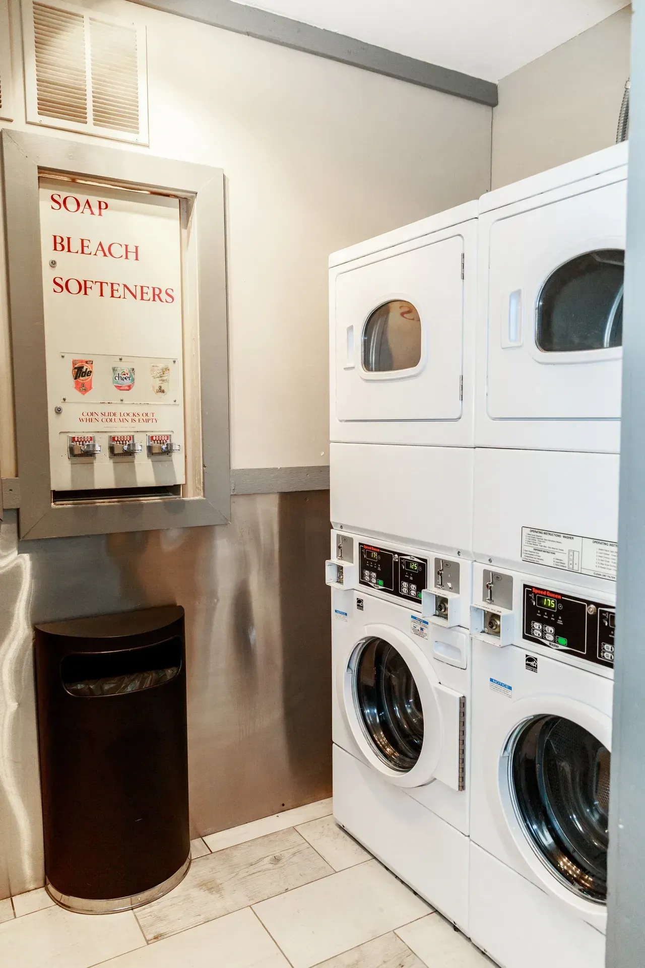 A laundromat with washers and dryers stacked on top of each other.