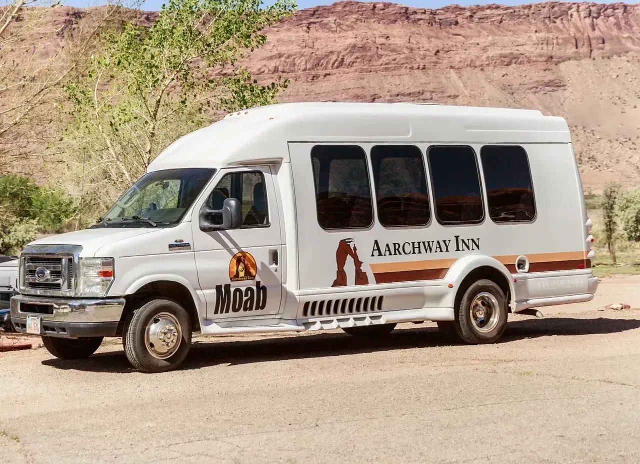 A white moab van is parked on the side of the road