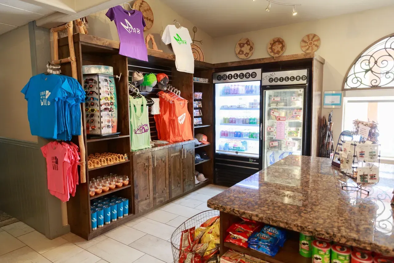 A store filled with lots of t-shirts and snacks.