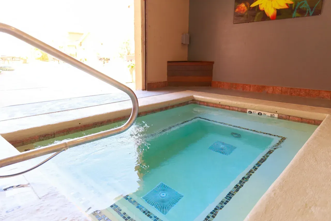A small swimming pool with a staircase leading to it.