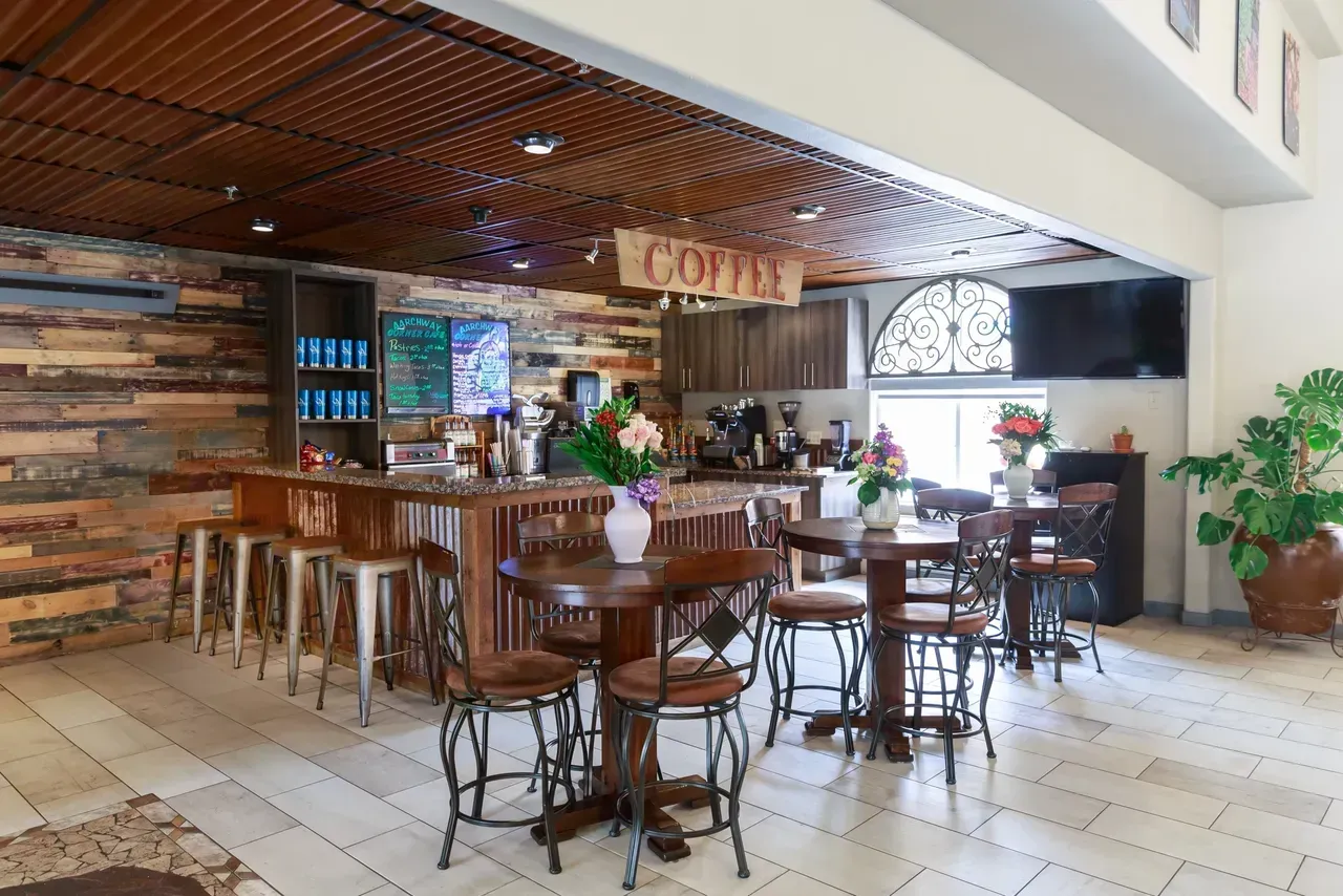 A restaurant with tables and chairs and a sign that says coffee
