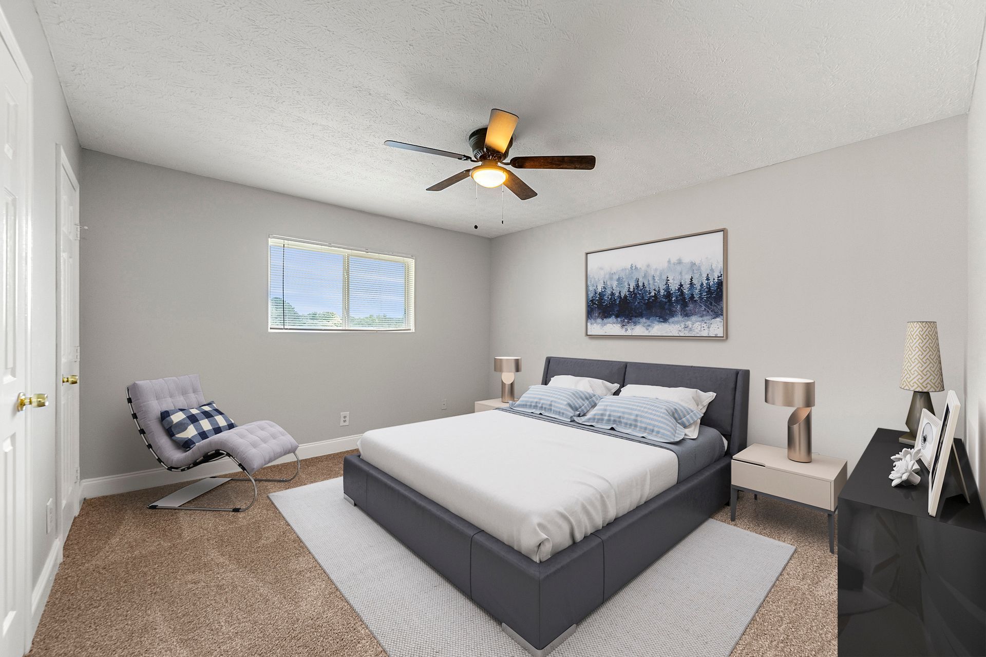 Modern bedroom with gray bed, chair, nightstands, wall art, and ceiling fan in a bright neutral room