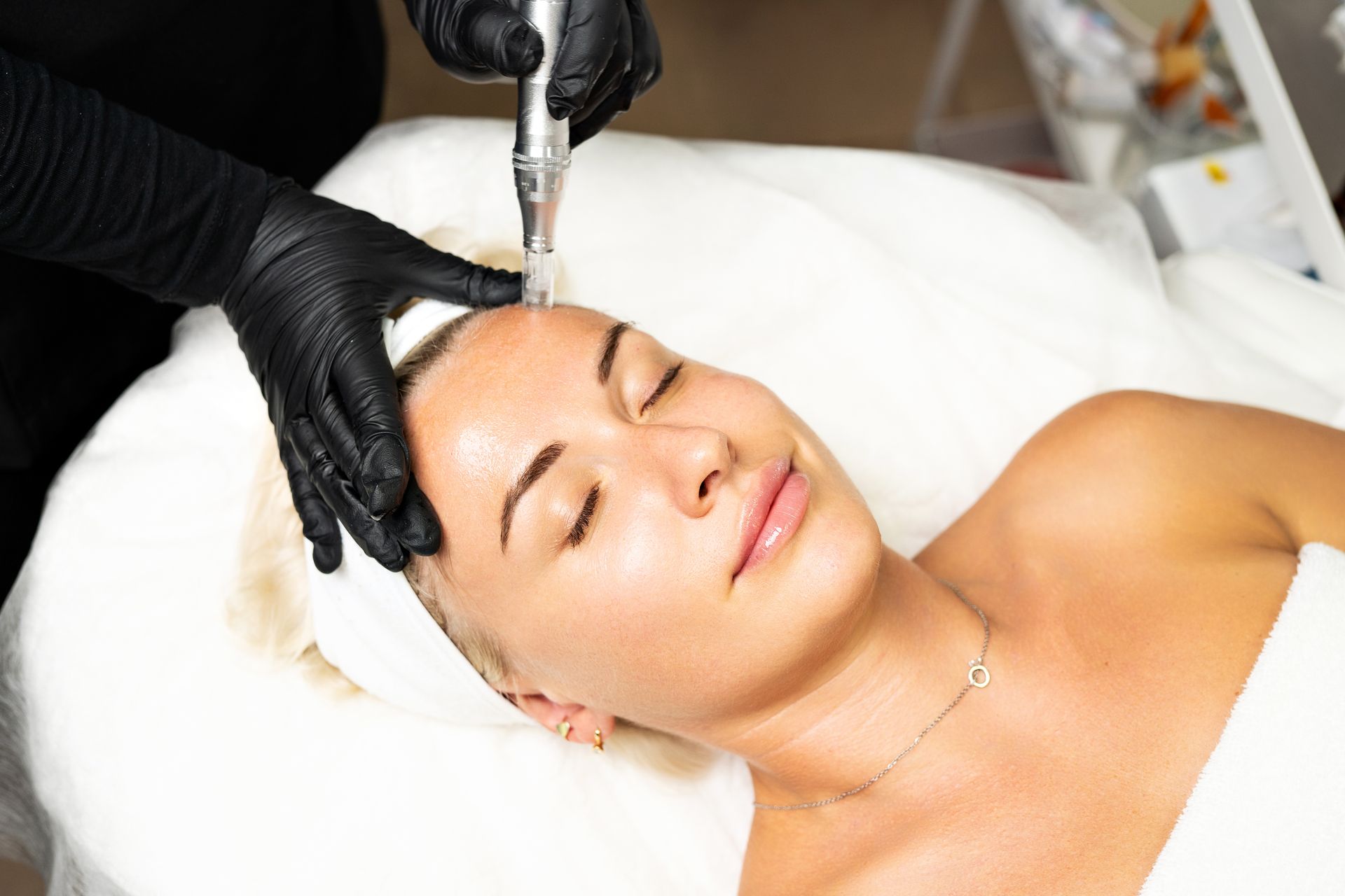 A woman is getting a facial treatment at a beauty salon.