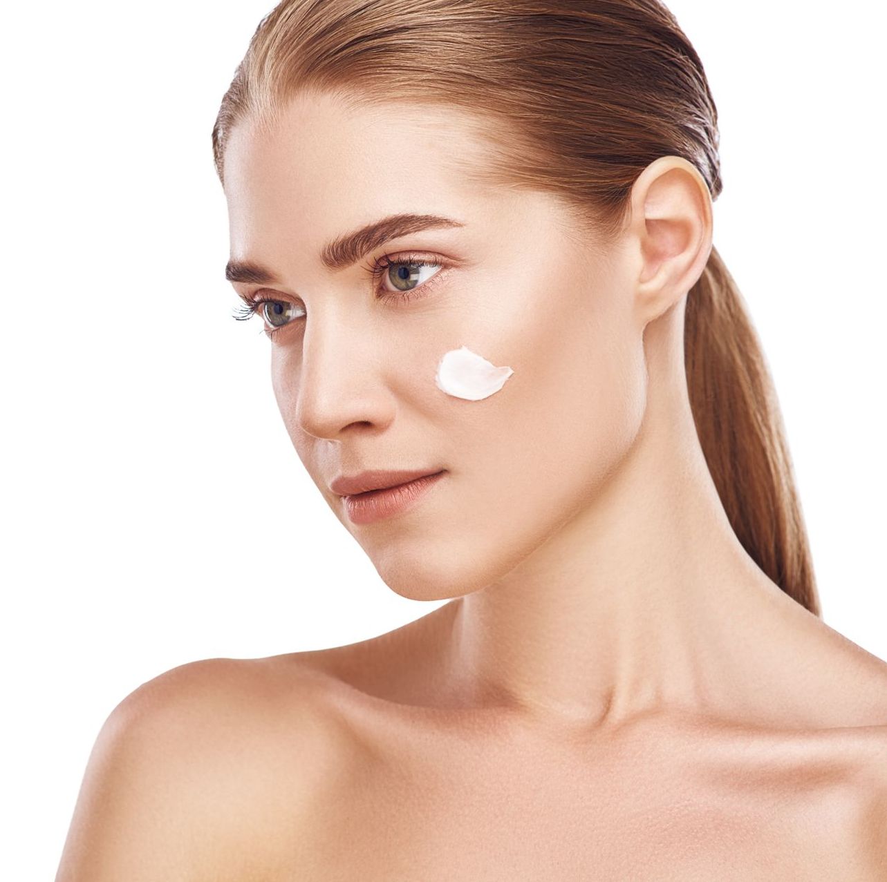 A woman with a patch of cream on her face