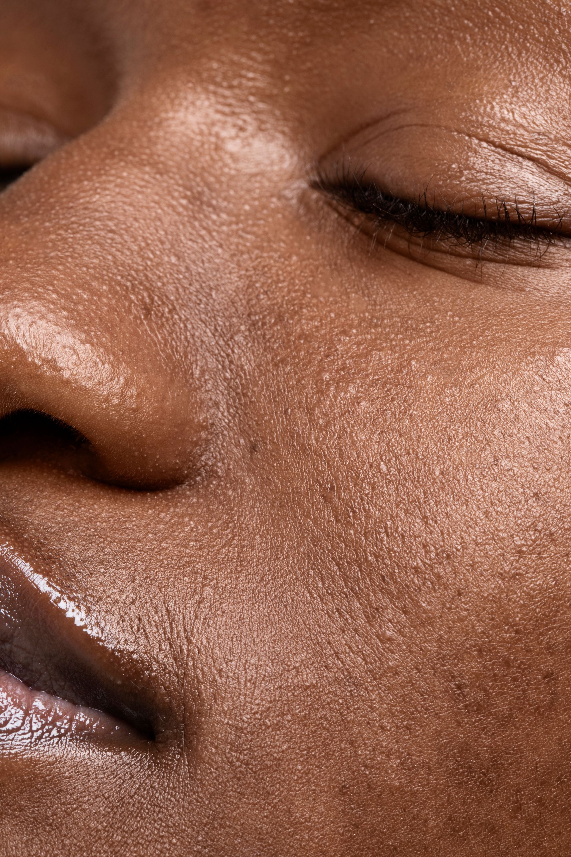 A close up of a woman 's face with her eyes closed.