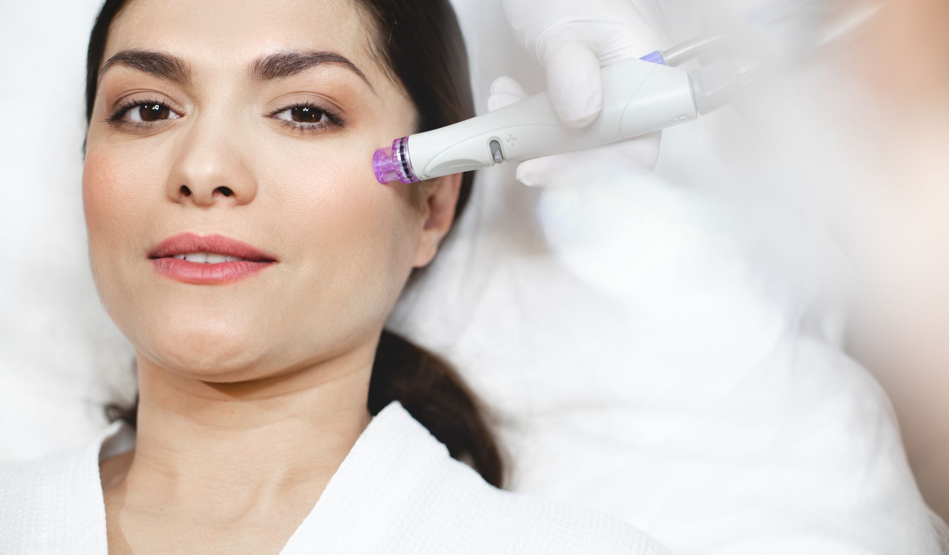 A woman is getting a facial treatment at a beauty salon.