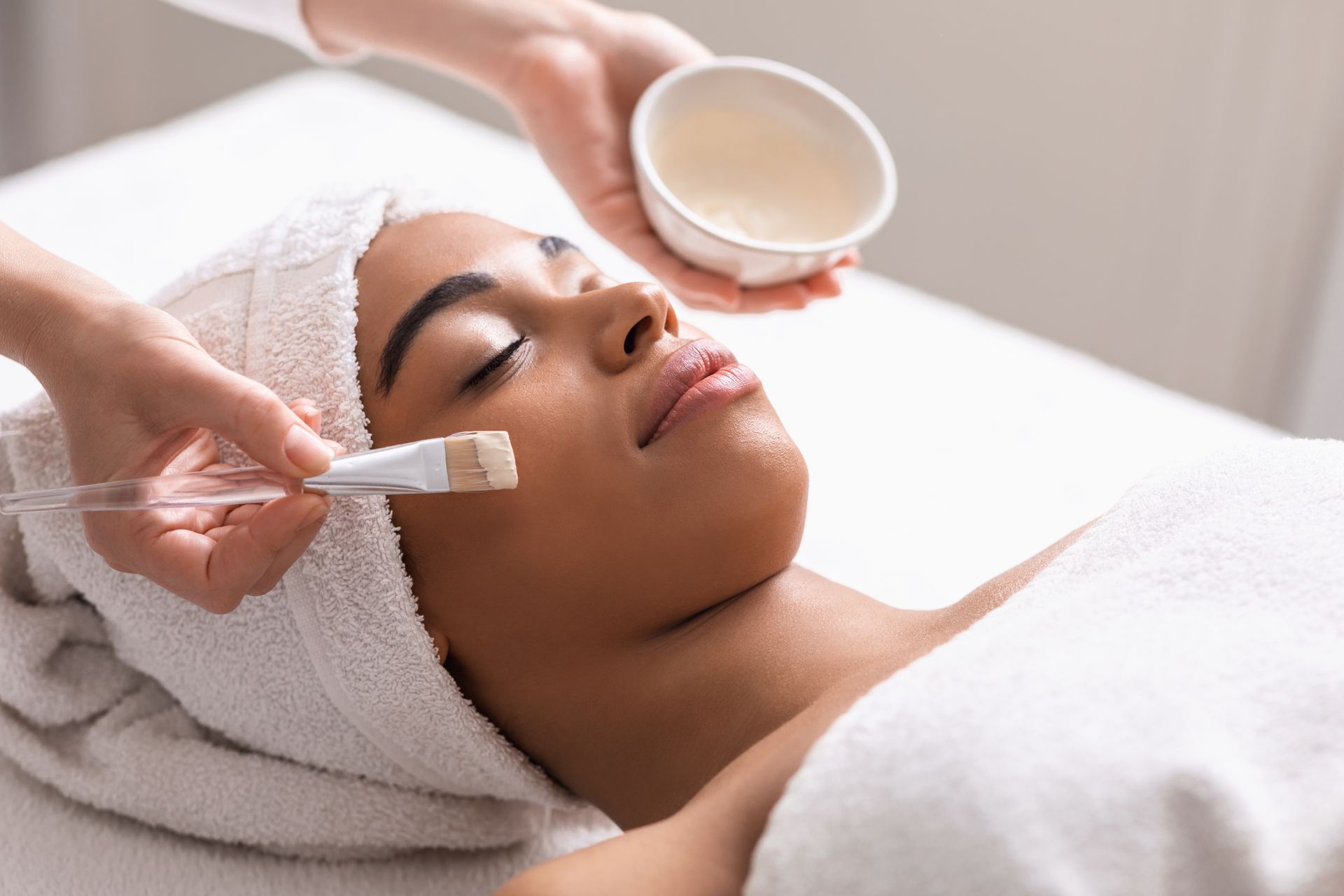 A woman is getting a facial treatment at a spa.