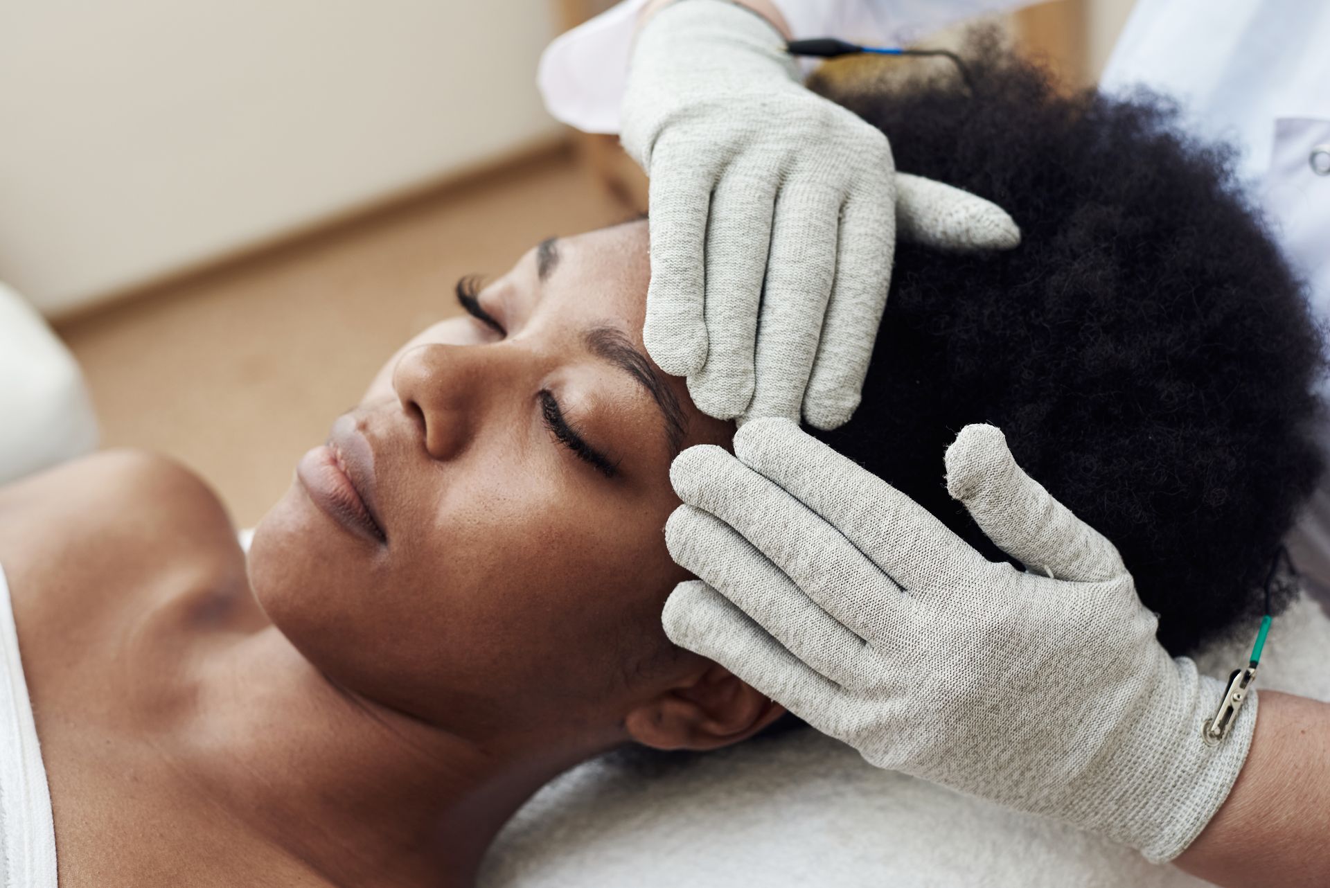 A woman is getting her eyebrows done at a beauty salon.
