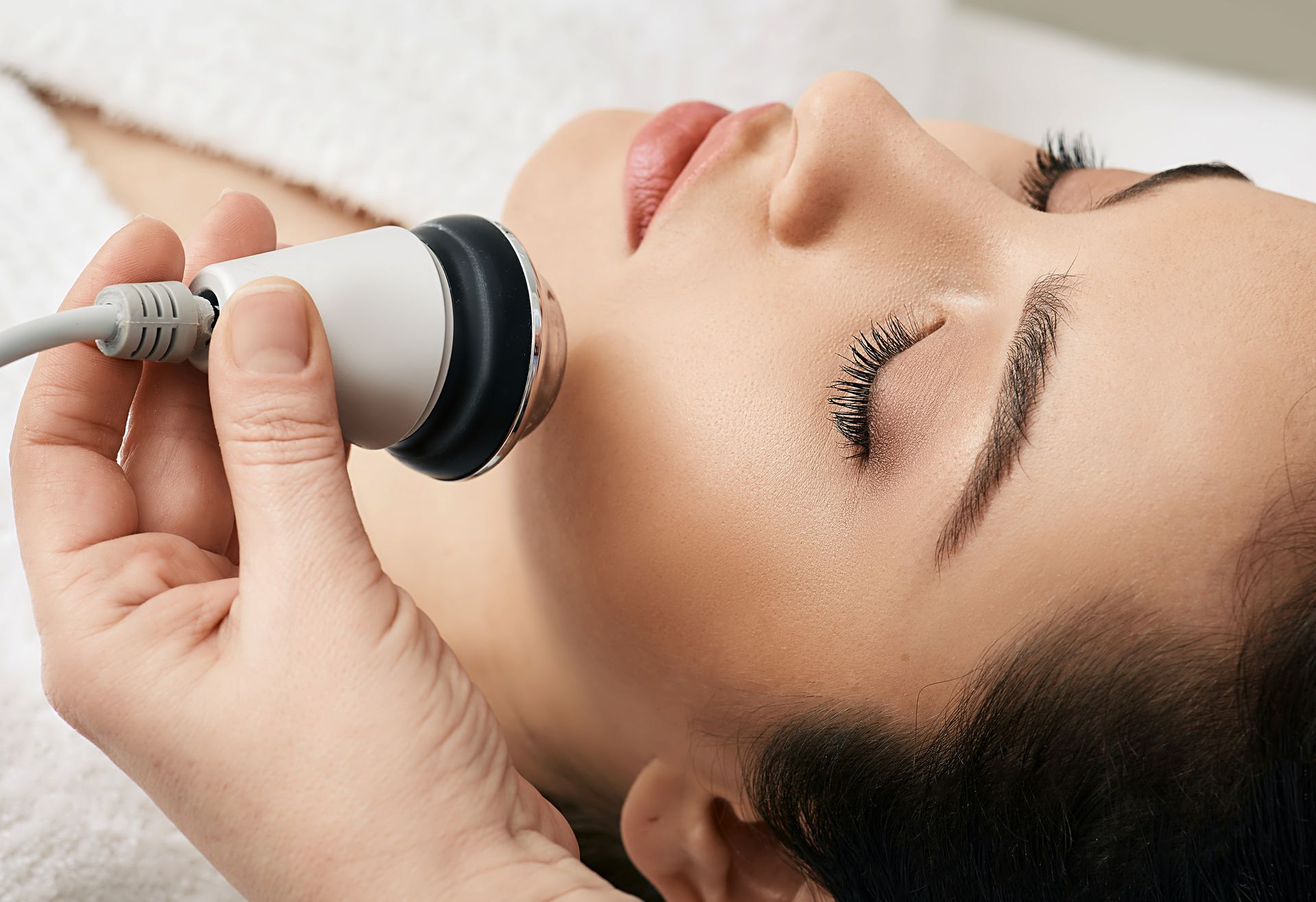 A woman is getting a facial treatment at a beauty salon.