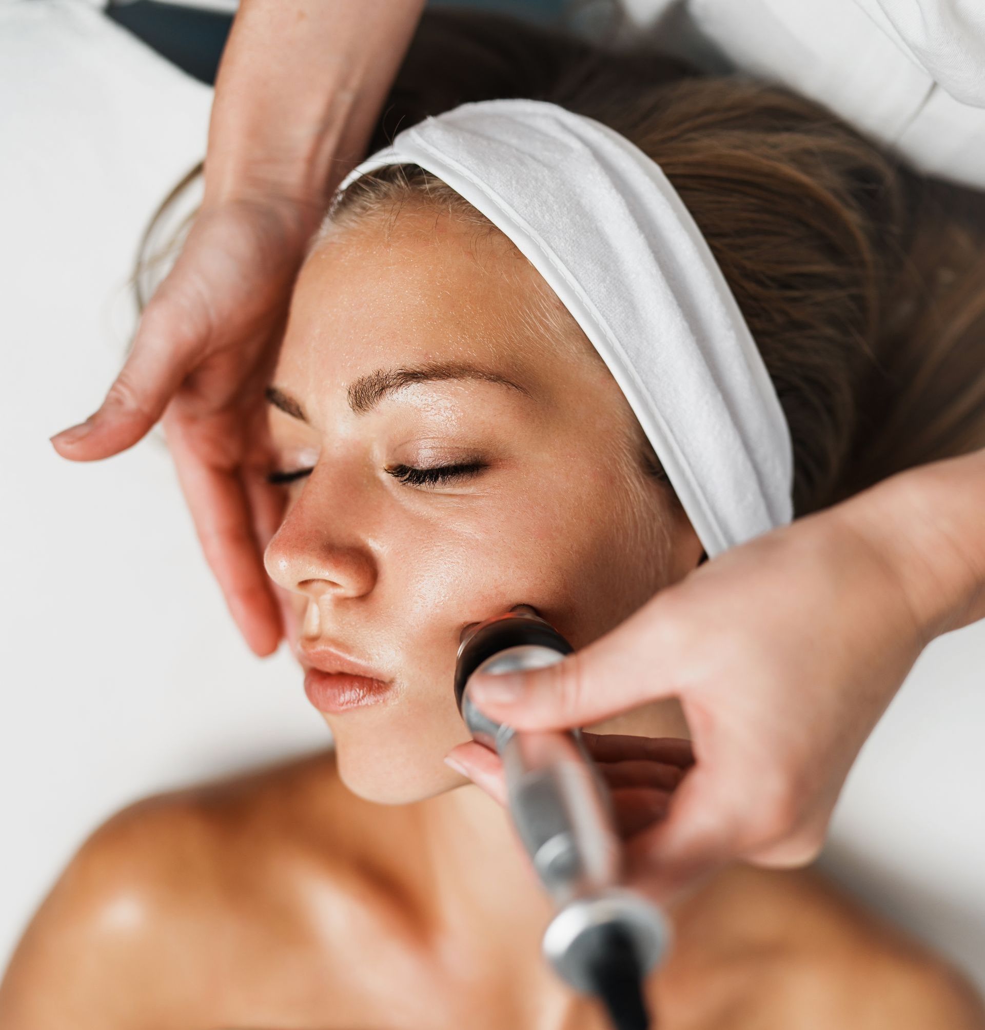 A woman is getting a facial treatment at a beauty salon.