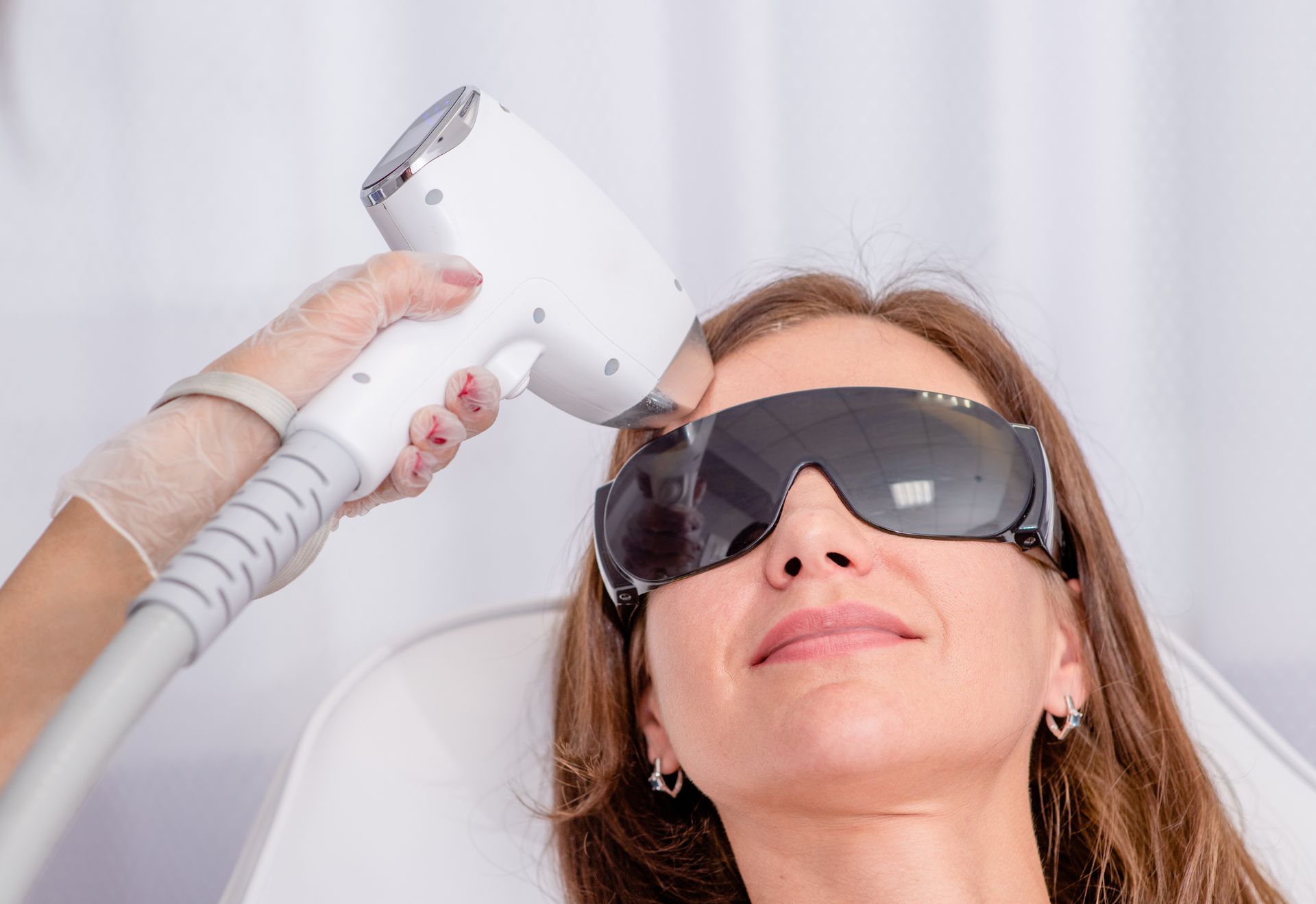 A woman is getting a facial treatment at a beauty salon.