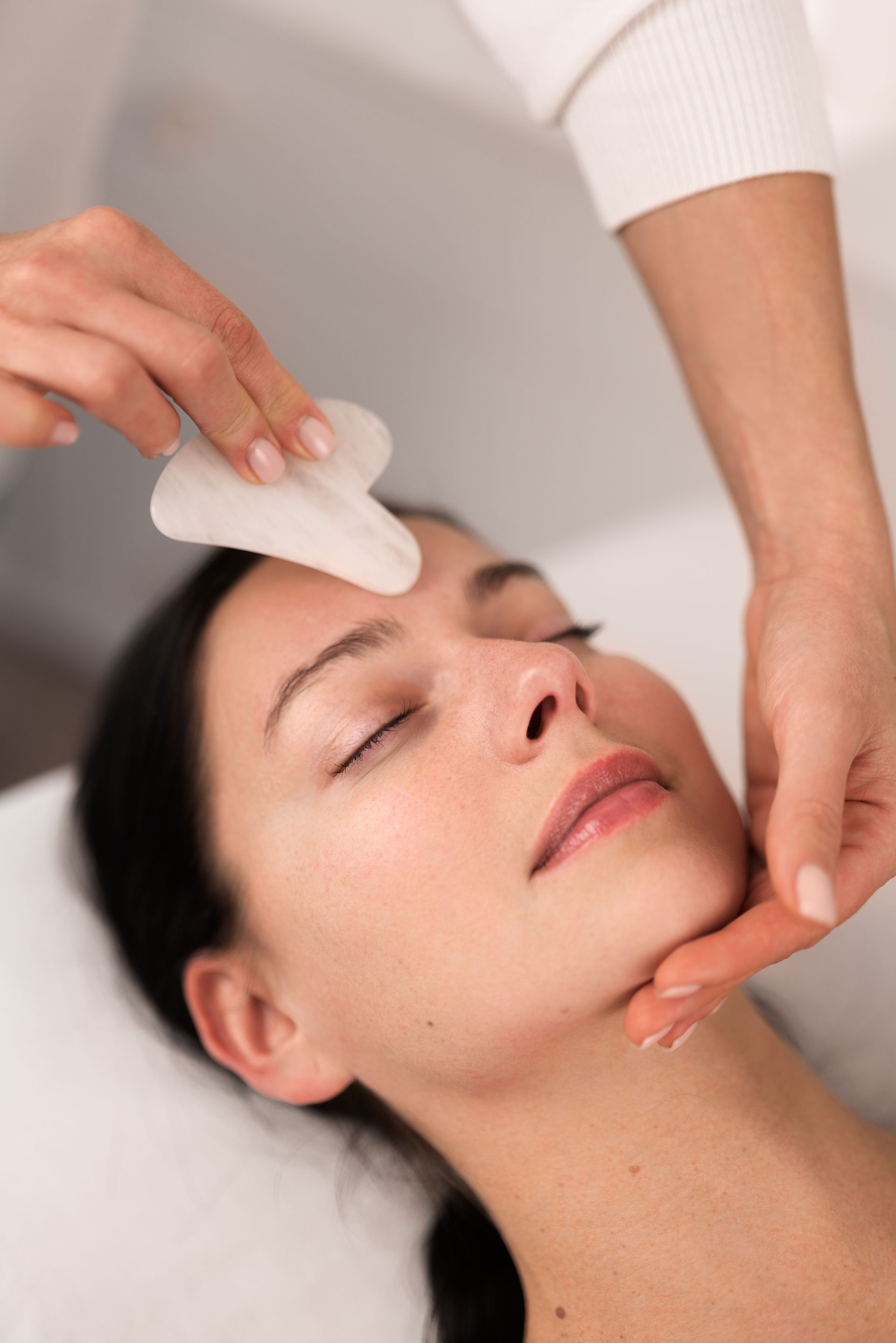 A woman is getting a facial treatment at a spa.