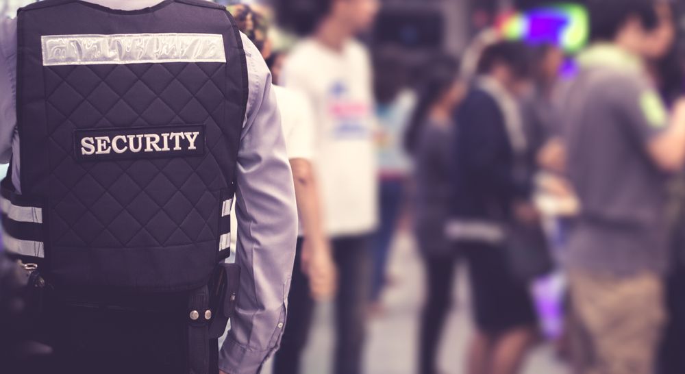 A Security Guard Wearing Vest in a Crowded Area — Clinton Security Services In Toowoomba, QLD