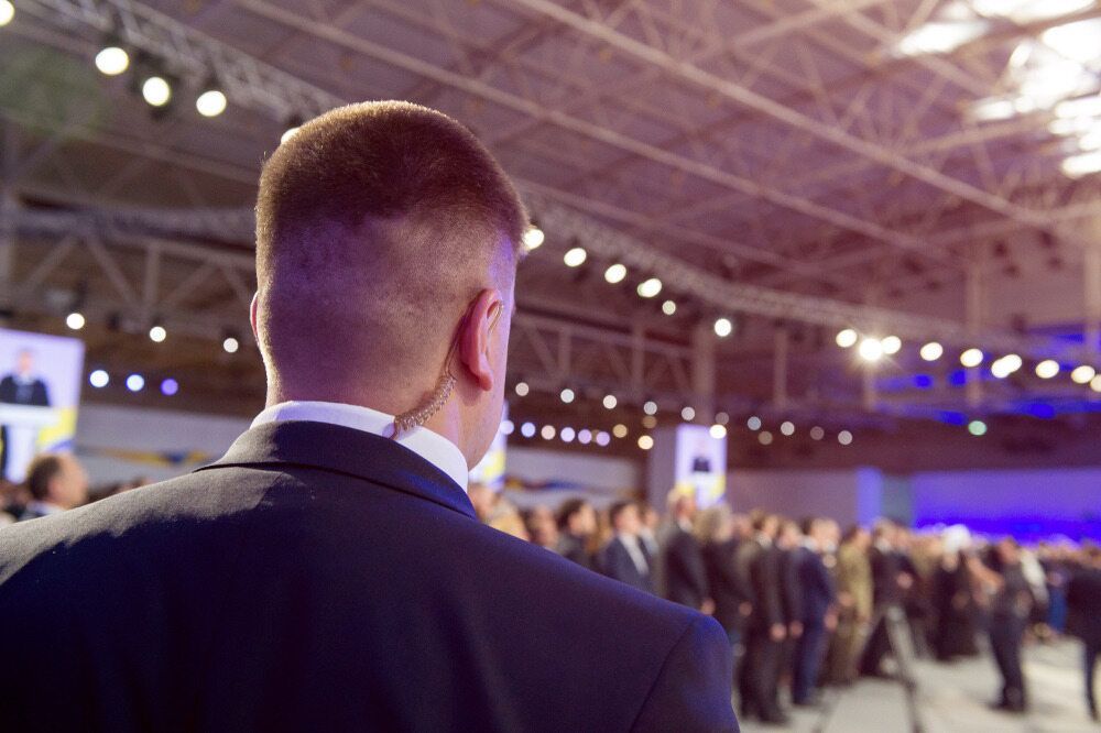Man Surveying a Crowded Event in a Large Hall — Clinton Security Services In Armidale, NSW