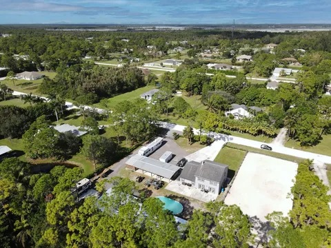 An aerial view of a residential area with lots of trees and houses.