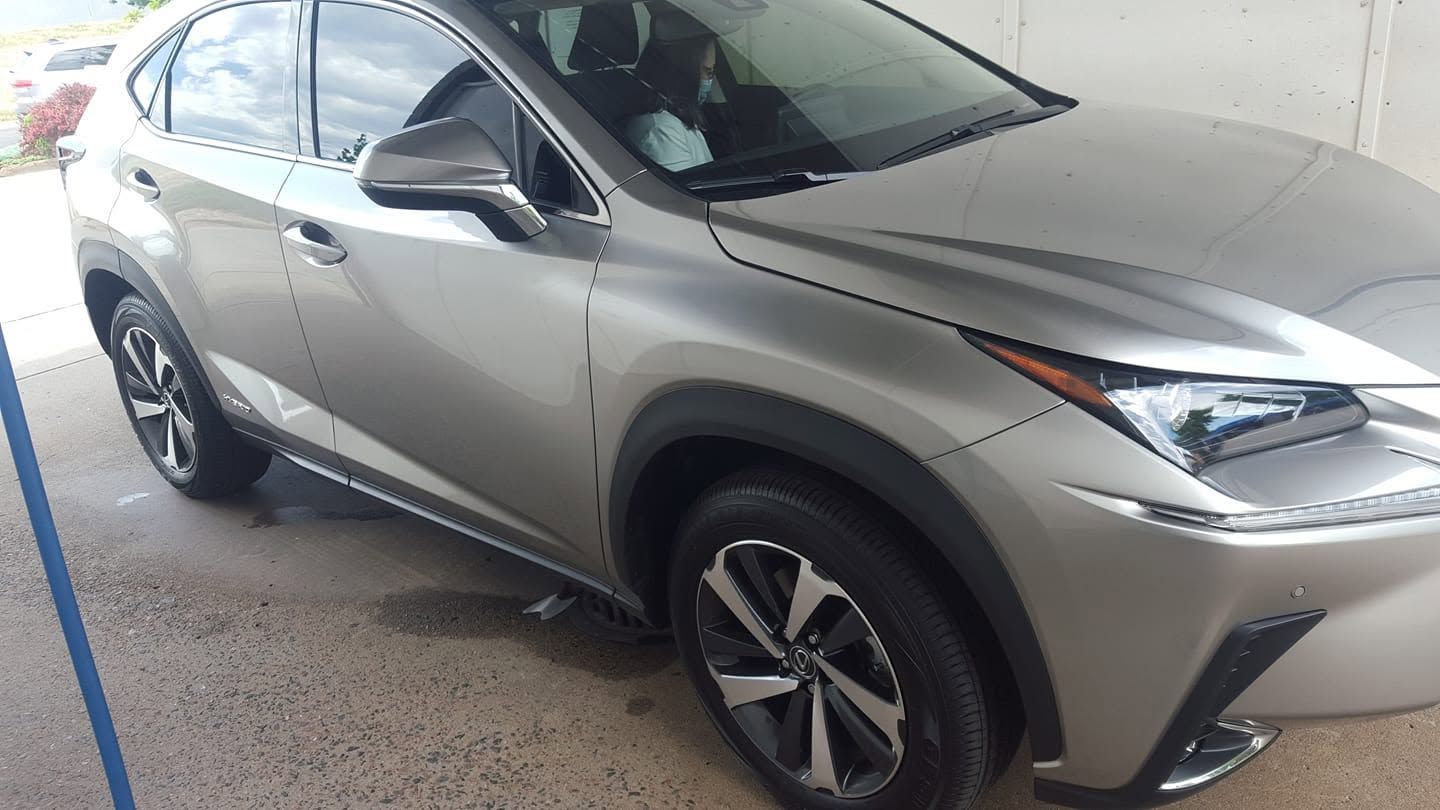 Silver SUV parked indoors, front-left view on a wet concrete floor