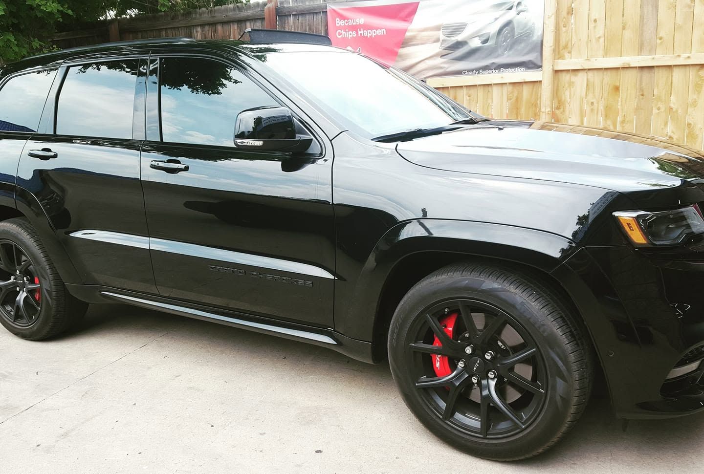 Black SUV parked outdoors with tinted windows and red brake calipers