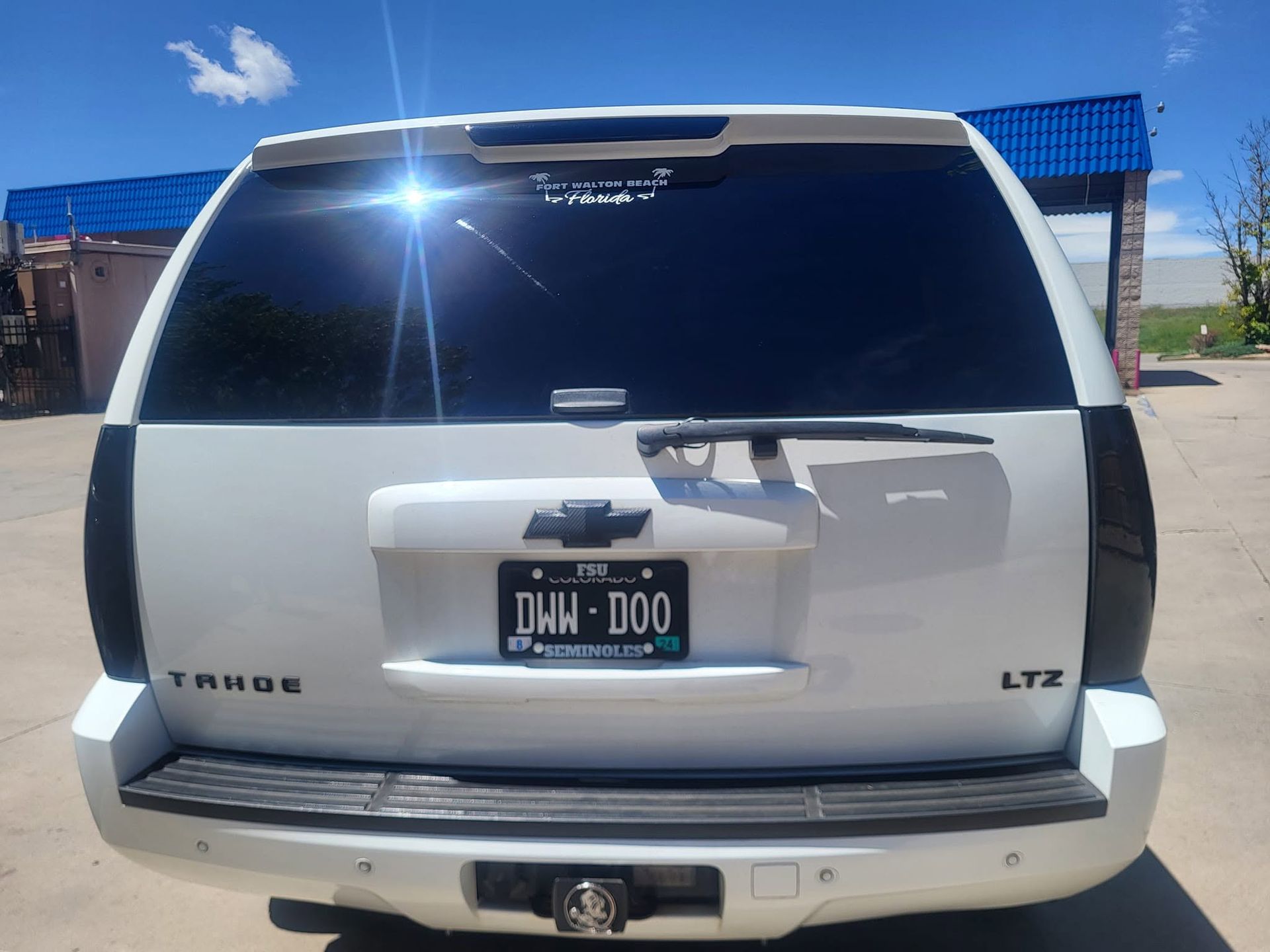 Rear view of a white Chevrolet Tahoe LTZ SUV with dark tinted windows and an Ohio license plate.