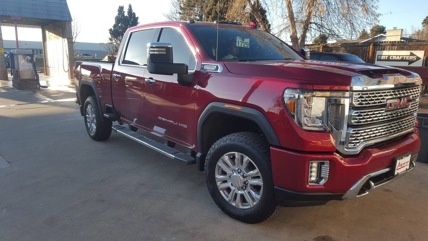 Red GMC pickup truck parked outdoors in daylight.