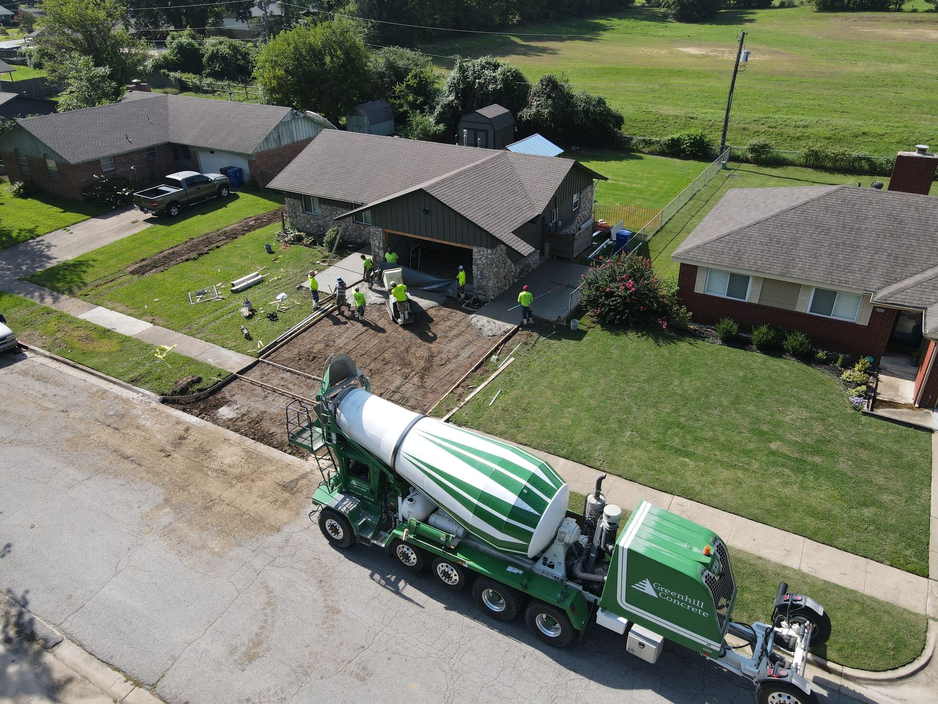 Concrete steps leading down, surrounded by brown mulch.