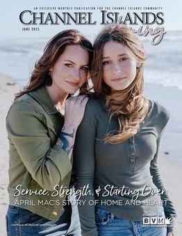 Two people stand side-by-side on a beach, posing for the cover of Channel Islands Living magazine.