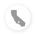 A grey silhouette of California centered on a white circle, with a location pin marker in the southern region.