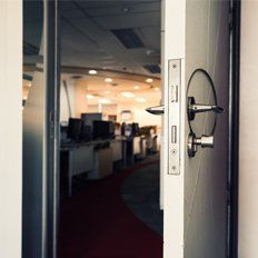 A locksmith opening an office door.