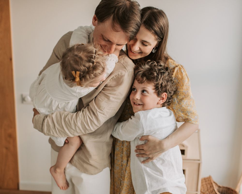 family embracing, dressed in all beiges