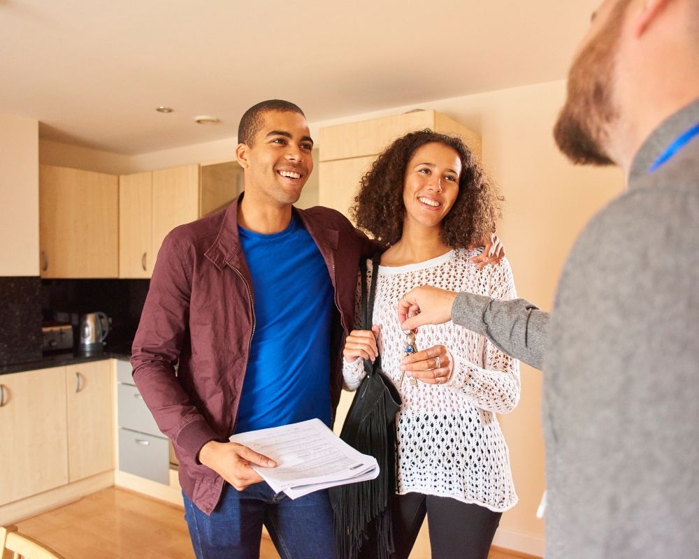 tenant holding up keys to camera