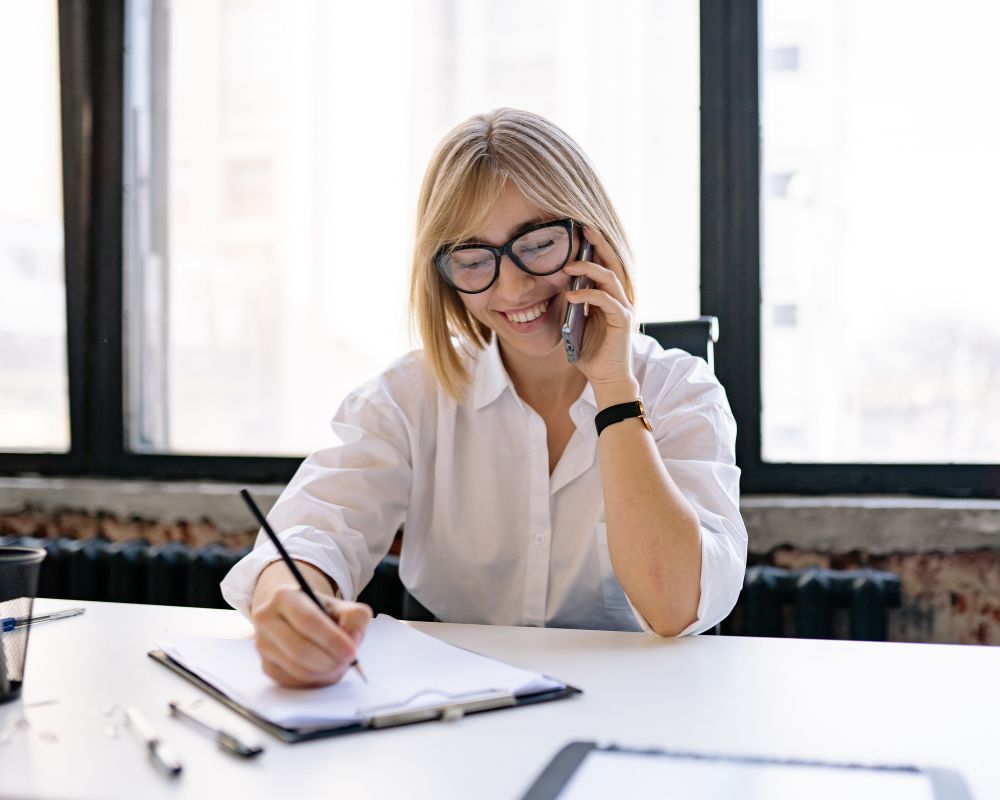 woman on phone writing
