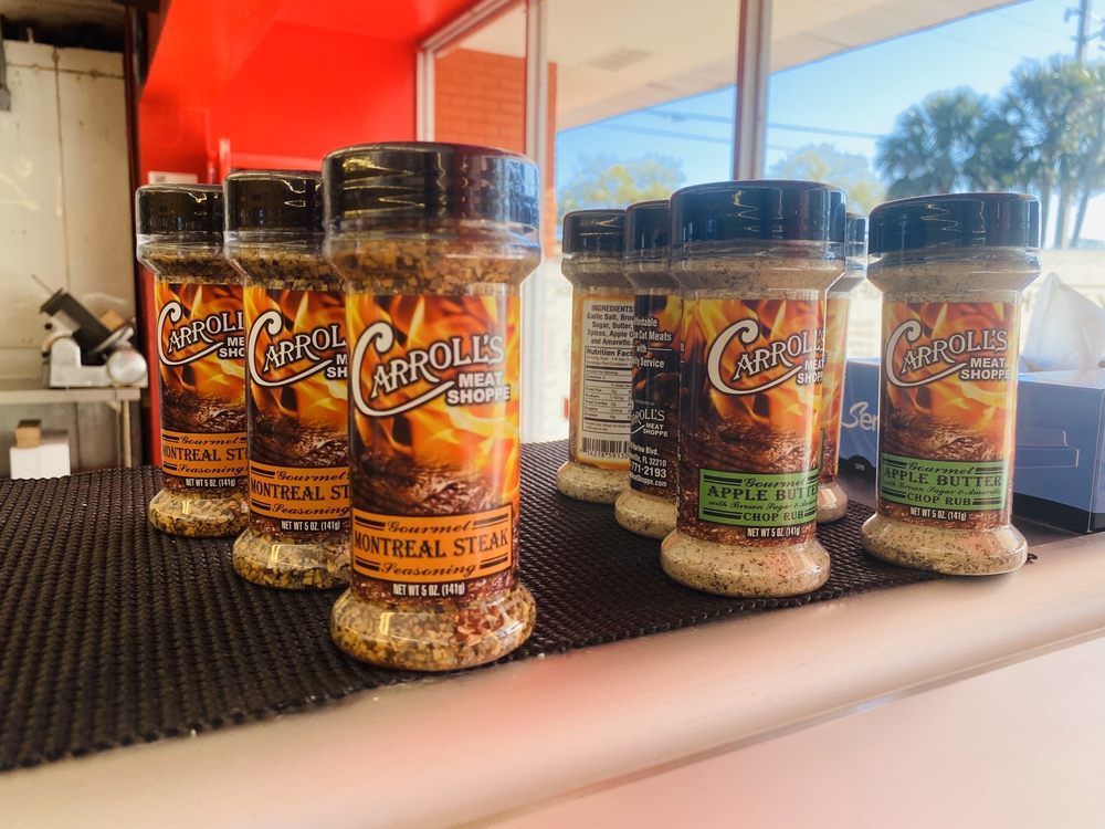 Spice jars labeled “Fire & Smoke Carrols” on a counter by a sunny window